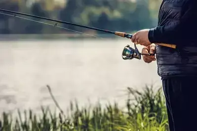 person holding fishing rod 