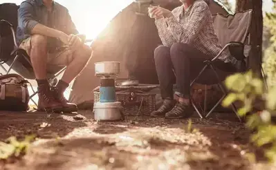 a couple sitting outside their tent