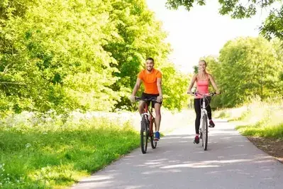 Happy couple riding bikes together.