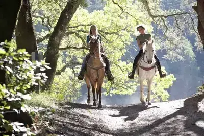 Two women enjoying Cades Cove horseback riding.